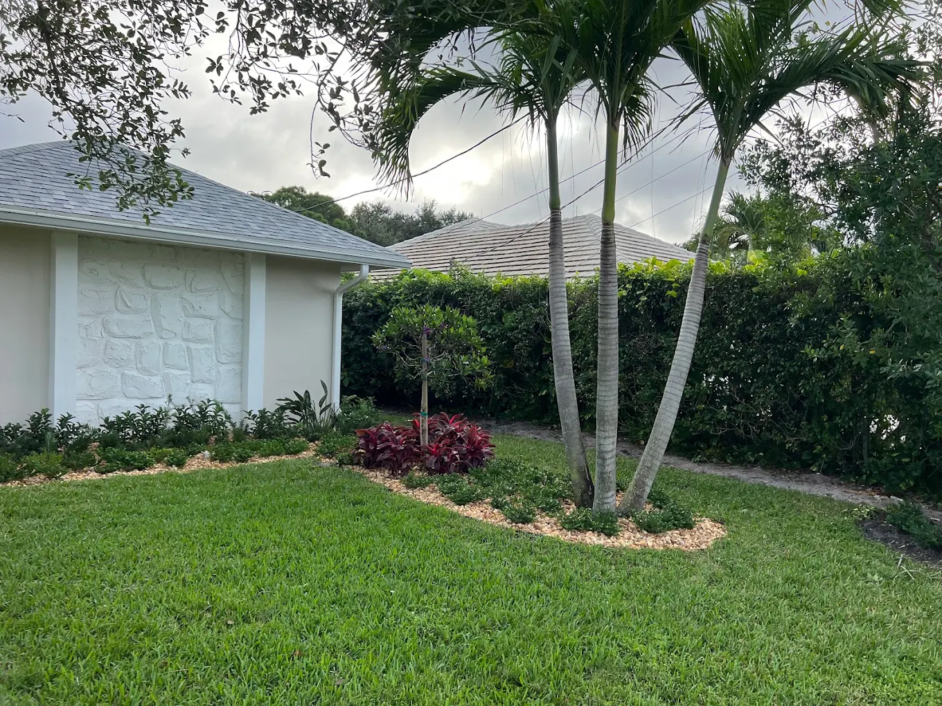 Satisfied customer with beautifully landscaped property by 3H Landscaping